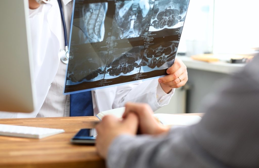 doctor checking patient image scans during a health screening