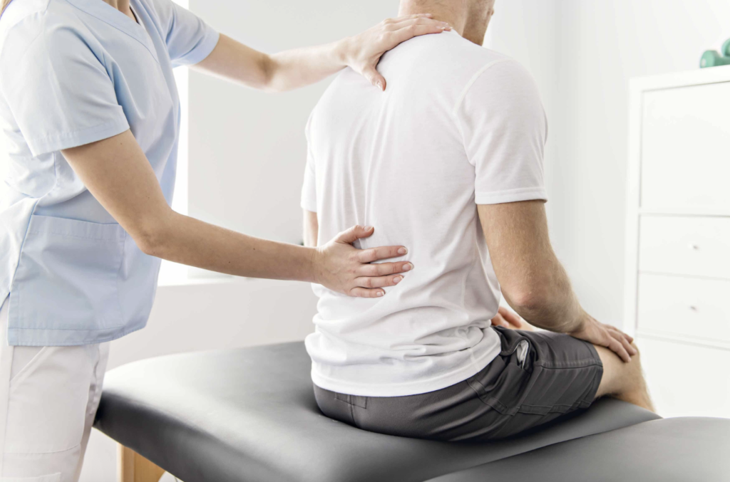 Doctor helping patient with spine pain